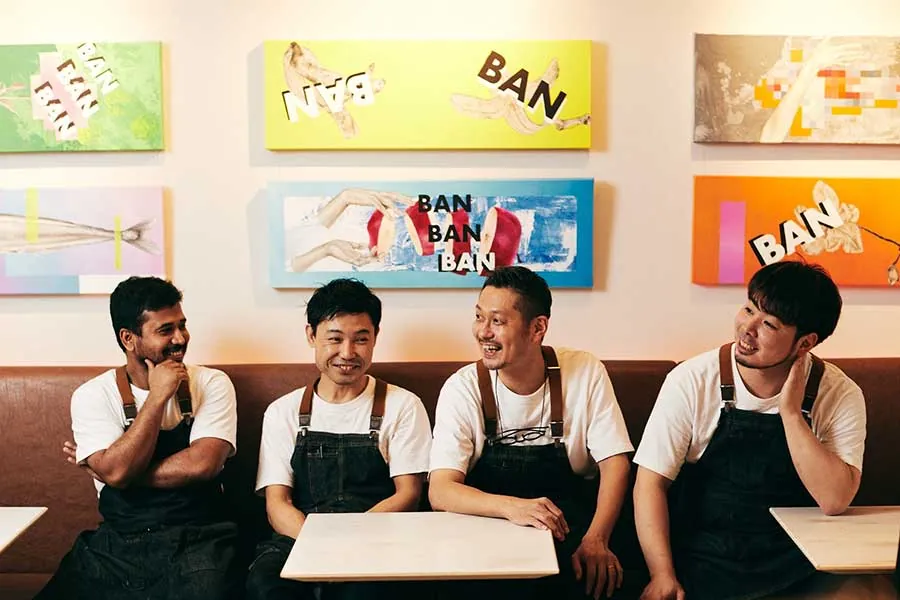 Four staff members in front of pop art