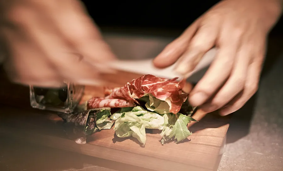Hands plating a dish
