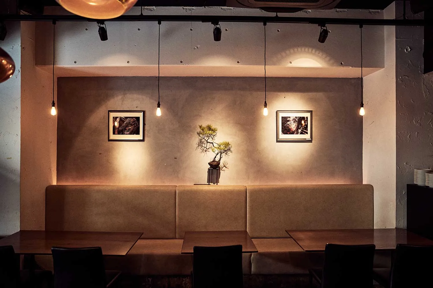 EX dining room with bonsai and a wall of photographs